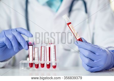 Doctor Holding Test Tube With Blood For 2019-ncov Analyzing. Covid-19 Virus, Coronavirus Blood Test 