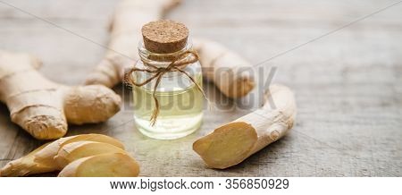 Ginger Essential Oil In A Small Bottle. Selective Focus.