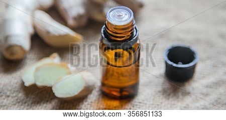 Ginger Essential Oil In A Small Bottle. Selective Focus.