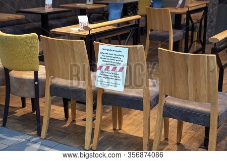 Ratzeburg, Germany, March 20, 2020: Chairs Stand As A Barrier In Front Of A Café And A German Massag