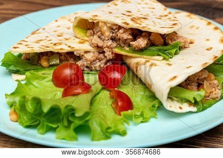 Fajitos With Minced Meat Vegetables In A Corn Tortilla On A Blue Plate Dark Wooden Background. Fast