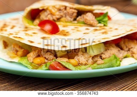 Fajitos With Minced Meat Vegetables In A Corn Tortilla On A Blue Plate Dark Wooden Background. Fast 