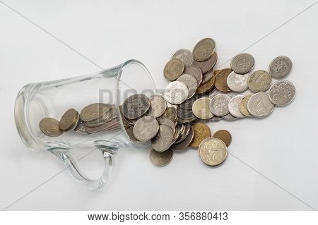 Trifle Russian Coins Pouring From A Glass Jar On A White Background, Concept Of Low-denomination Coi