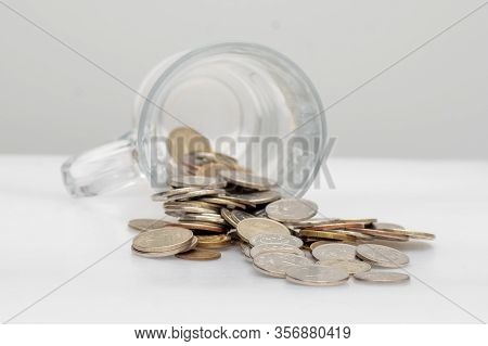 Trifle Russian Coins Pouring From A Glass Jar On A White Background, Concept Of Low-denomination Coi