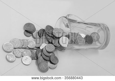 Trifle Russian Coins Pouring From A Glass Jar On A White Background, Concept Of Low-denomination Coi