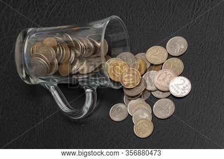 Trifle Russian Coins Pouring From A Glass Jar On A Black Background, Concept Of Low-denomination Coi