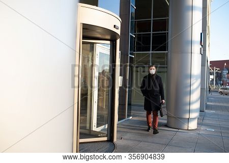 Caucasian Young Man Near His Office Wearing Surgical Face Mask To Protect From Coronavirus Covid-19