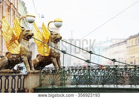 Two Griffins On Bank Bridge Crossing The Griboedov Canal Near The Former Banking Assignation In Sain