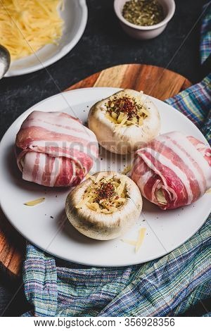 Preparing Of Bacon-wrapped Button Mushrooms Stuffed With Grated Cheddar Cheese And