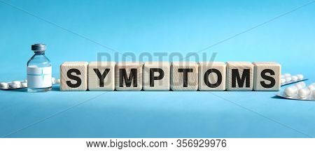Symptoms - Text On Cubes. Drug In Ambula, Tablets In Blisters To Reduce Disease Symptom. Medical Con