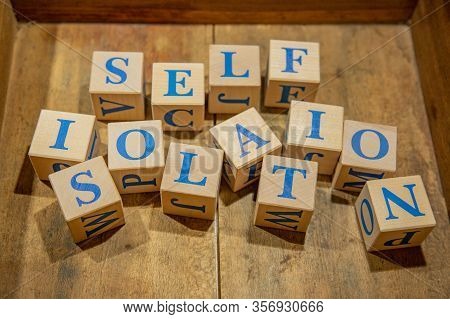 Self-isolation. Wooden Cubes With Blue Letters