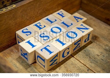 Self-isolation. Wooden Cubes With Blue Letters