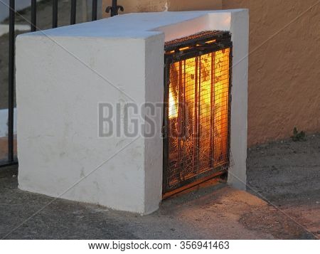 Spotlight Encased In Small Concrete Box With Melal Grill For Protection Ponted At Local Attraction