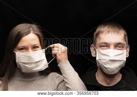 And Funny People, A Man And A Woman In Protective Medical Antimicrobial And Anti- Bacterial Masks Fr
