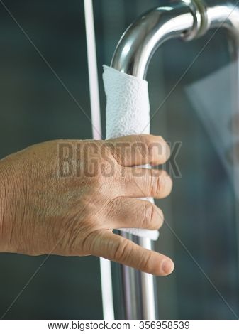 Woman Using Tissue To Hold The Door Stainless Steel Handle To Prevent Germs Protect Colona Virus, Co