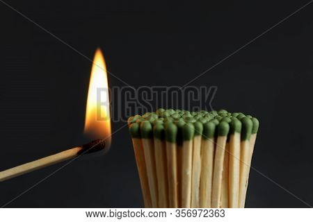 Burning Match Near Unlit Ones On Dark Background, Closeup