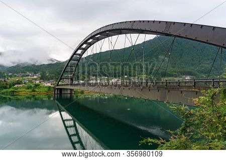 River Bridge In Japanese Countryside With Rural Village View. Kiso Valley, Japan