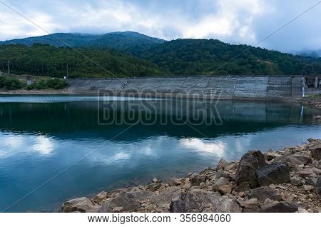 Mountain Lake Landscape. Nozori Lake With Dam Wall Surrounded By Mountains. Gumna, Japan