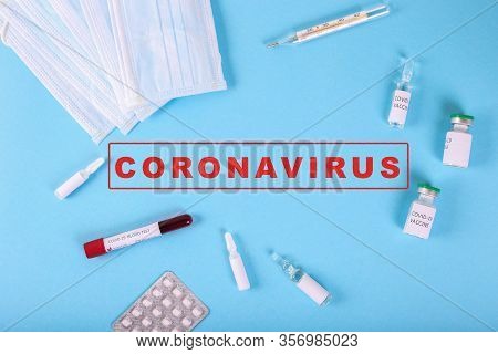 Top View Of Positive Covid-19 Test And Medical Mask, Vaccine And Pills. Medicine Infectious Concept.