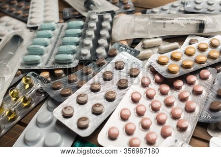 Closeup Shot Of Different Pills On Table With Tablets , Pharmaceutical Industry Concept