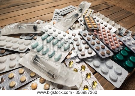 Closeup Shot Of Different Pills On Table With Tablets , Pharmaceutical Industry Concept