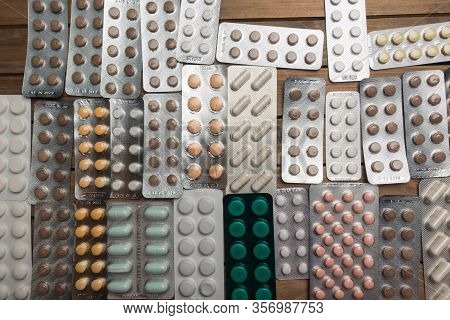 Closeup Shot Of Different Pills On Table With Tablets , Pharmaceutical Industry Concept