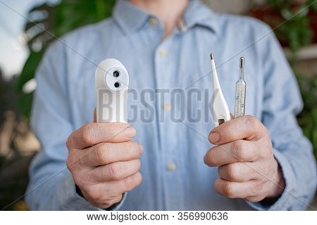 Person Hold Various Thermometers. Mercury , Digital And Non-contact Thermometers. People And Healthc