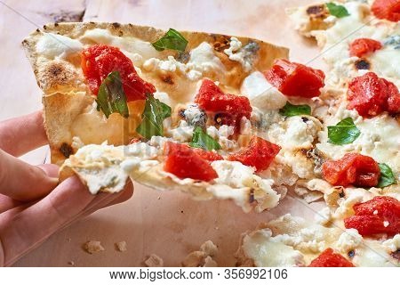 Man Eating French German Traditional Dish Tarte Flambee Flammekueche On Wooden Cutting Board