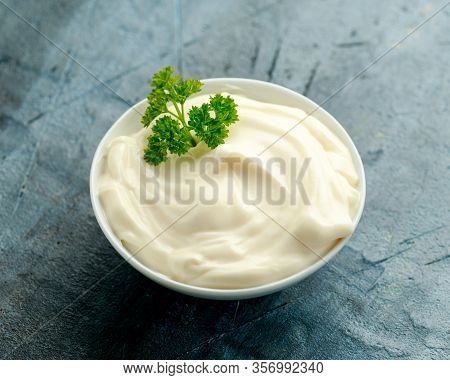 Mayonnaise Sauce In A White Bowl On Old Rustic Table