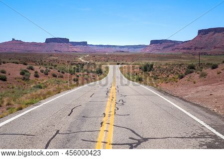 Us Road 128 Winding Through Utah Desert Between Red Cliffs On Abeautiful Day Of Spring. Scenic Drive