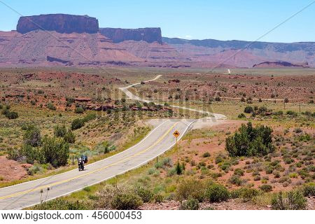 Us Road 128 Winding Through Utah Desert Between Red Cliffs On Abeautiful Day Of Spring. Scenic Drive