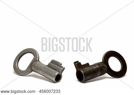 Close Up Of Two Small Old Retro Vintage Keys For U-locks On White Background