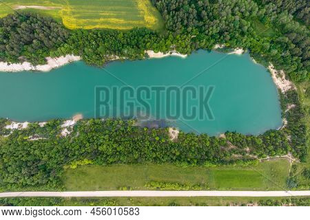 Ariel Top View Of An Old Flooded Lime Quarry With Turquoise Water
