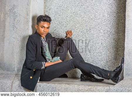 A Young 18 Years Old Black American Student, Wearing Fashionable Blazer, Pants, Leather Shoes, Sitti