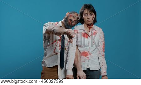 Disapproving Horror Looking Monsters Acting Bizarre While Giving Thumbs Down At Camera On Blue Backg
