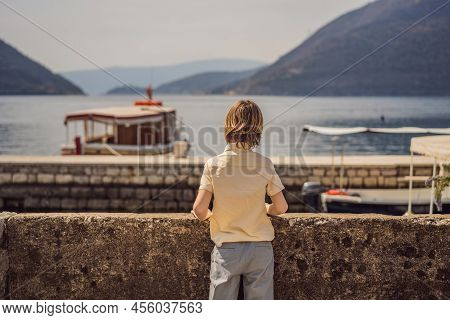 Boy Tourist Enjoying Colorful Street In Old Town Of Perast On A Sunny Day, Montenegro. Travel To Mon