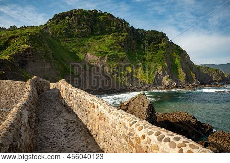 Stone Footpath To Famous Landmark And Film Location In North Of Spain, Ocean Islet With Chapel San J