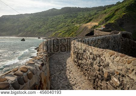 Stone Footpath To Famous Landmark And Film Location In North Of Spain, Ocean Islet With Chapel San J