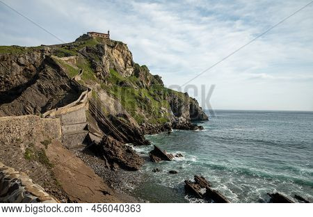 Stone Footpath To Famous Landmark And Film Location In North Of Spain, Ocean Islet With Chapel San J