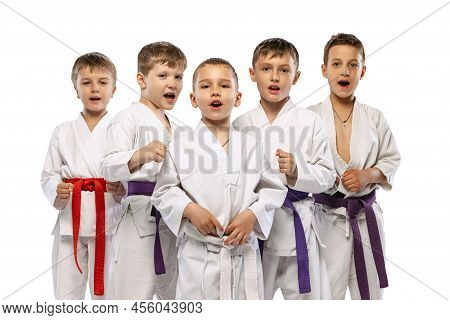 Group Of Happy Children, Beginner Karate Fighters In White Doboks Standing Together Isolated On Whit