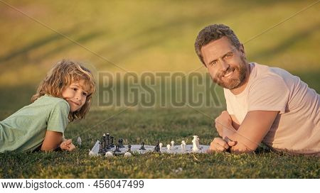 Strategic And Tactic. Tutorship. Dad And Kid Play Logic Game. Father And Son Playing Chess