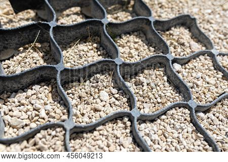 Geogrid Used At Base Of New Pedestrian Road, Road Construction, Reinforcement Covered With Fine Grav