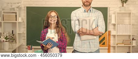Happy Teen Girl And Cropped Teacher Man In High School With Workbook At Blackboard, Estudy