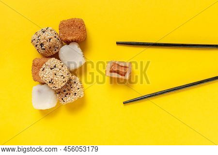 Japanese Dessert Packaged Set On A Yellow Background. Japanese Ice Cream Mochi In Rice Dough. Tradit
