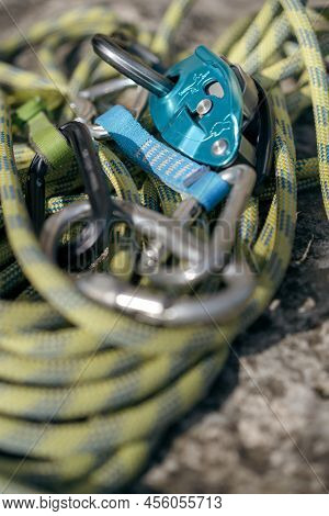 Close Up Shot Of A Rock Climbing Assisted Belaying Device And A Green Rope.