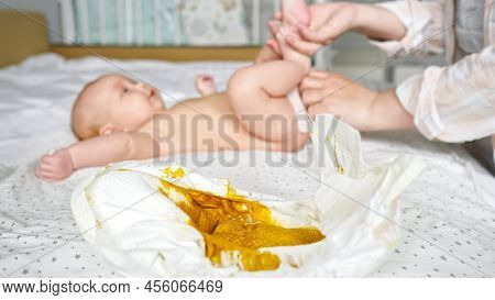 Mother Hands Clean Newborn Daughter Body With Wet Wipes After Changing Dirty Diaper. Bare Baby Girl 
