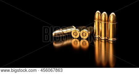 Pistol Cartridges 9 Mm On A Smooth Glossy Surface With Reflections. Ammunition For Pistols And Pcc C
