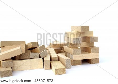 A Bunch Of Jenga Game Details Lie On A White Background.