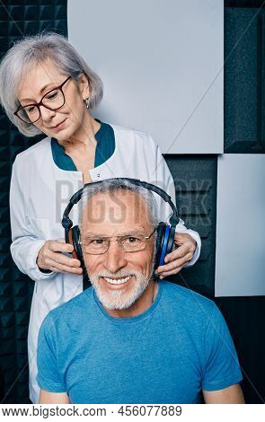 Audiometry, Pure Tone Audiogram Test. Audiologist Doing Hearing Exam To Mature Man In Soundproof Aud