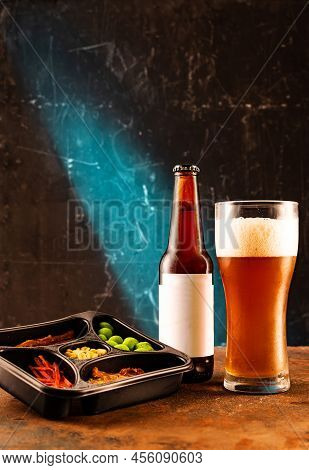Dark Craft Beer In Glass And Bottle. Cool Foamy Beer And Fish Snack. Fish And Nuts For Beer. Bright 